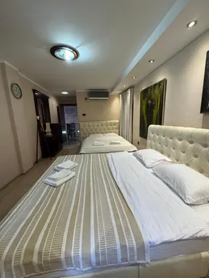 a large bed with white sheets and towels on it at Vita Mundo in Kotor