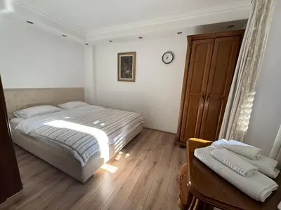 a bedroom with a bed and a clock on the wall at Vita Mundo in Kotor