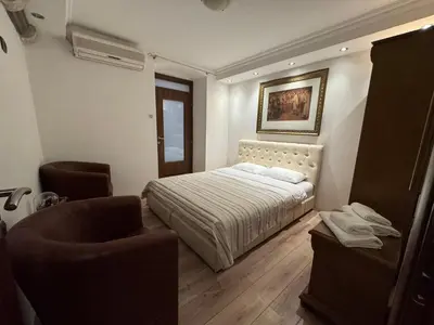 a small bedroom with a bed and a chair at Vita Mundo in Kotor