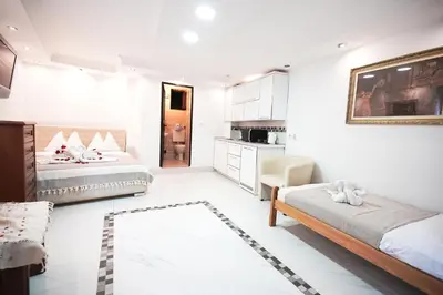 a living room with two beds and a kitchen at Vita Mundo in Kotor