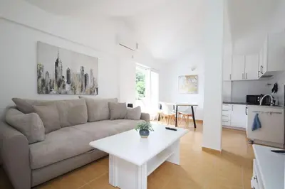 a living room with a couch and a table at Status-M Apartments Seoce 26 in Budva