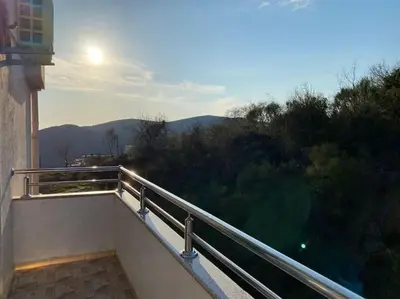 a balcony of a building with the sun in the background at Status-M Apartments Seoce 26 in Budva