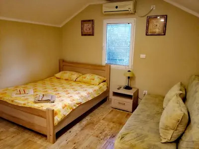 a bedroom with two beds and a window at INO Apartments in Tivat