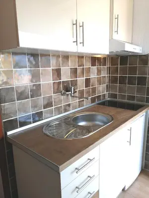 a kitchen with a sink on a counter at INO Apartments in Tivat