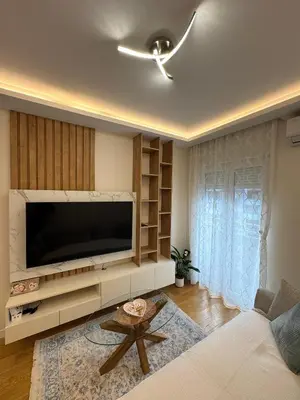 a living room with a large flat screen tv at Stan AP Central Podgorica in Podgorica
