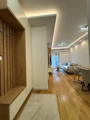 a living room with a couch and a living room with at Stan AP Central Podgorica in Podgorica