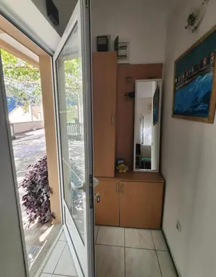 a room with a sliding glass door and a mirror at Apartments Ksenija in Kotor