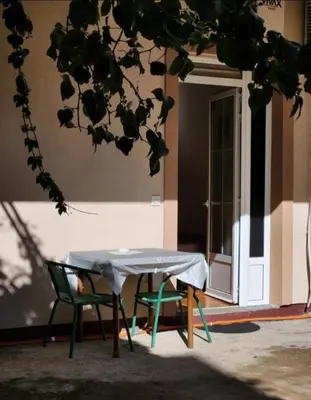 a table and two chairs in front of a building at Apartments Ksenija in Kotor