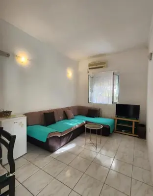 a living room with a couch and a table at Apartments Ksenija in Kotor
