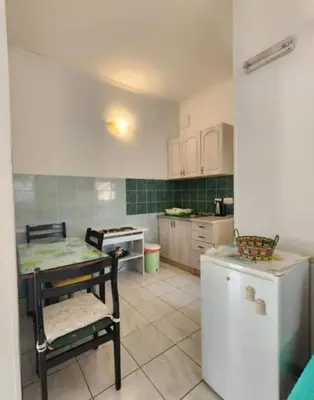 a kitchen with a table and a table and a stove at Apartments Ksenija in Kotor