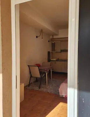 a living room with a table and a dining room at Apartments Ksenija in Kotor