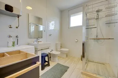 a bathroom with a shower and a sink and a toilet at Sky Fort Apartment in Dobra Voda