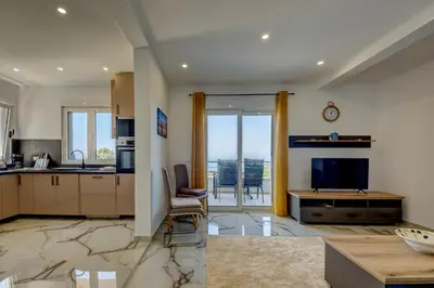 a living room with a kitchen and a television at Hamburg in Utjeha