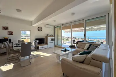 a living room with a couch and a table at Penthouse Sunce in Dobra Voda