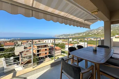 a balcony with a table and chairs and a view at Penthouse Sunce in Dobra Voda