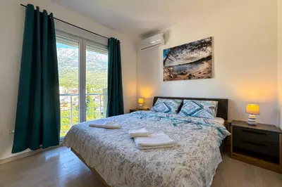 a bedroom with a bed with two towels on it at Penthouse Sunce in Dobra Voda