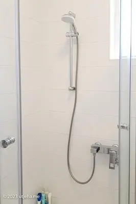 a shower with a shower head in a bathroom at Sunset Penthouse in Utjeha