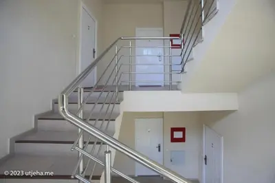 a spiral staircase in a building with white walls at Sunset Penthouse in Utjeha