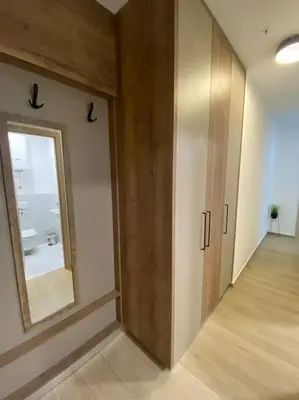 a hallway with a mirror and a door in a room at Modern 2BR Apt in Rafailovići - Near the Beach in Budva