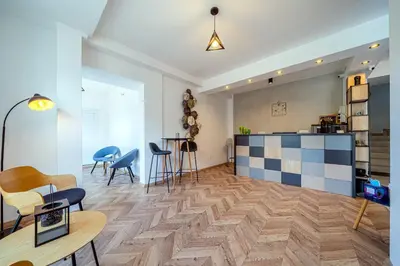 a living room with a table and chairs at Sun and Sea Apartments in Budva