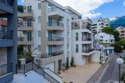 an apartment building with balconies and a street at Sun and Sea Apartments in Budva