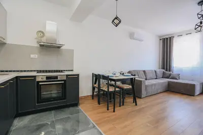 a kitchen and living room with a couch and a table at Top27 in Budva