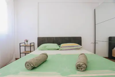 a bedroom with a bed with towels on it at Top27 in Budva