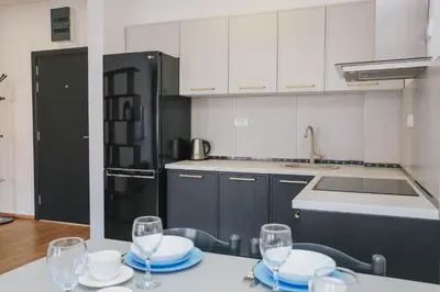 a kitchen with a table with plates and wine glasses at Top27 in Budva