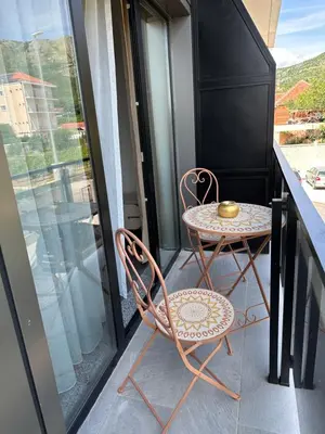 a small table and two chairs on a balcony at Avio Apartments in Podgorica
