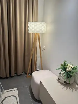 a living room with a chair and a table and a lamp at Avio Apartments in Podgorica