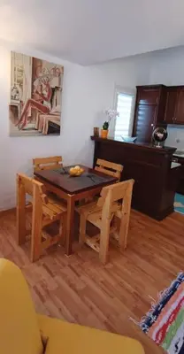 a dining room with a wooden table and chairs at Apartment Matko Budva in Budva