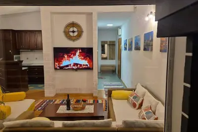 a living room with a couch and a fire in the wall at Apartment Matko Budva in Budva