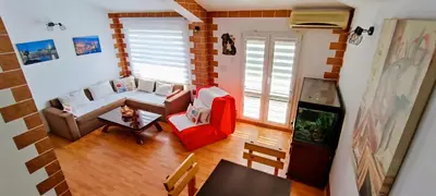 an overhead view of a living room with a couch and chairs at Apartment Matko Budva in Budva