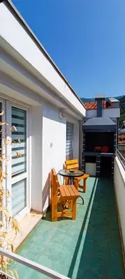 a patio with a table and benches and a grill at Apartment Matko Budva in Budva