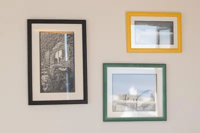 a group of three framed photographs on a white wall at Tre canne cozy sea view apartment in Budva