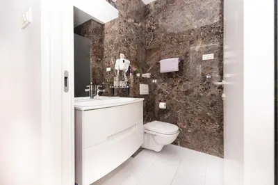 a bathroom with a sink and a toilet at Tre canne cozy sea view apartment in Budva