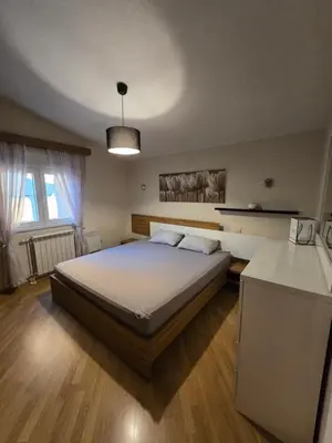 a bedroom with a large bed in a room at UnaTea Suites in Bar