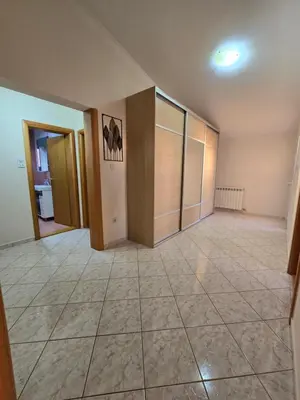 a large empty room with a large tile floor at UnaTea Suites in Bar