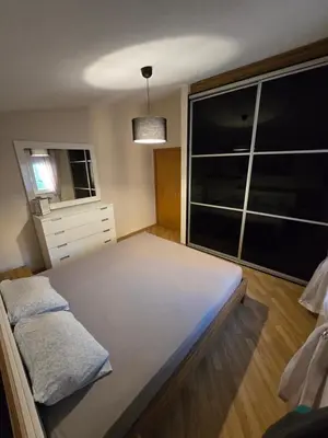 a bedroom with a bed and a large window at UnaTea Suites in Bar