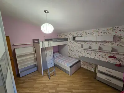 a bedroom with two bunk beds and a desk at UnaTea Suites in Bar