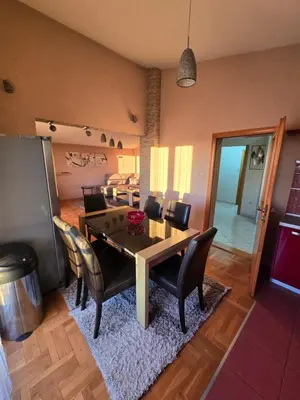 a dining room with a table and chairs at UnaTea Suites in Bar
