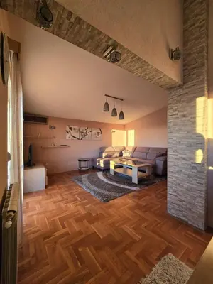 a living room with a couch and a table at UnaTea Suites in Bar