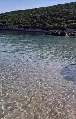 a large body of water with rocks in it at Villa Symphony apartments Kotor Tivat in Kotor
