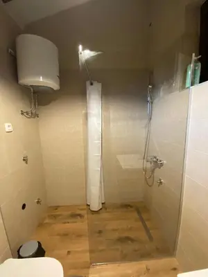 a small bathroom with a shower and a toilet at Cevna River in Podgorica