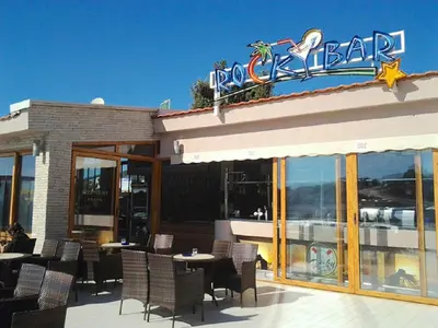 a restaurant with tables and chairs and a sign on it at Villa Blanca in Utjeha