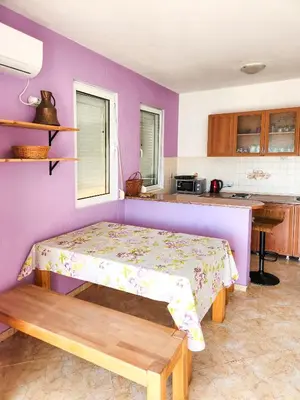 a bedroom with a bed and a purple wall at Villa Blanca in Utjeha