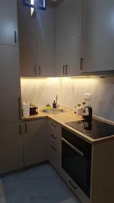 a kitchen with a sink and a stove at Ella Lux Apartment in Podgorica