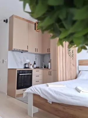 a kitchen with a bed and a stove top oven at Ella Lux Apartment in Podgorica