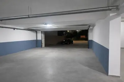 an empty garage with a car parked in it at Apartment Jana Meerblick mit Balkon nähe Sandstrand in Becici