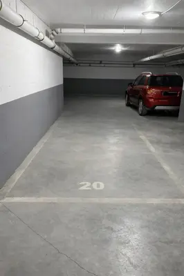 a parking garage with a red car parked in it at Apartment Jana Meerblick mit Balkon nähe Sandstrand in Becici